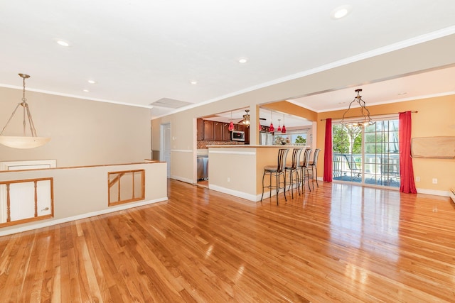 unfurnished living room with recessed lighting, baseboards, ornamental molding, and light wood finished floors