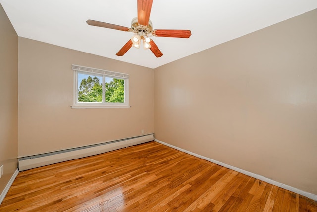 unfurnished room with baseboards, ceiling fan, wood finished floors, and baseboard heating