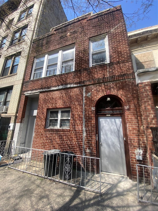 1241 College Ave, Bronx, NY 10456 - view of front facade with fence and brick siding