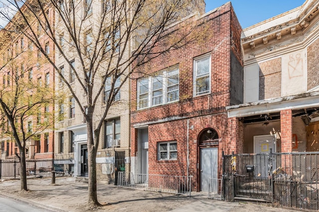 1241 College Ave, Bronx, NY 10456 - multi unit property with brick siding, cooling unit, fence, and a gate