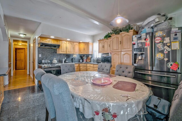 kitchen with appliances with stainless steel finishes, decorative backsplash, light brown cabinetry, and under cabinet range hood