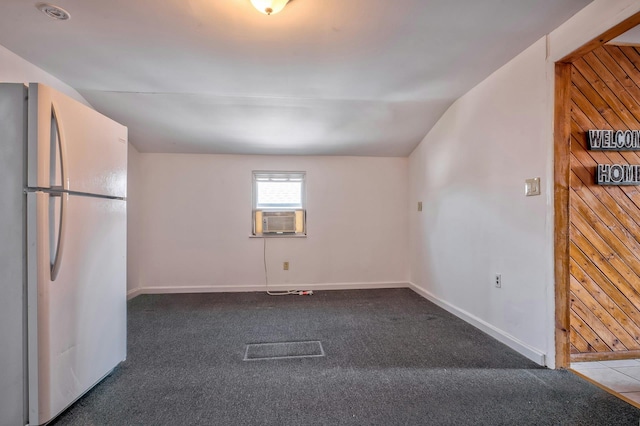 carpeted spare room with cooling unit and baseboards