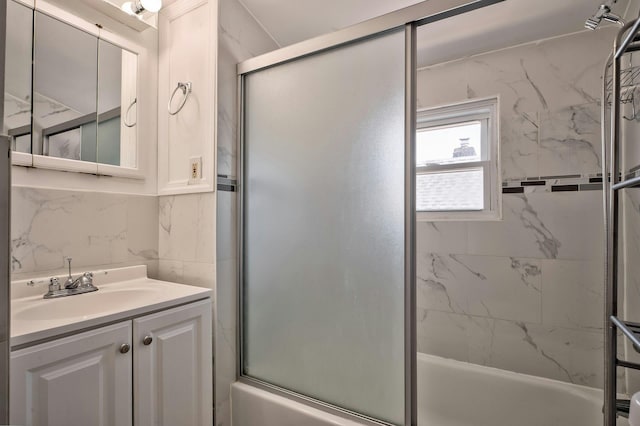 bathroom with bath / shower combo with glass door and vanity
