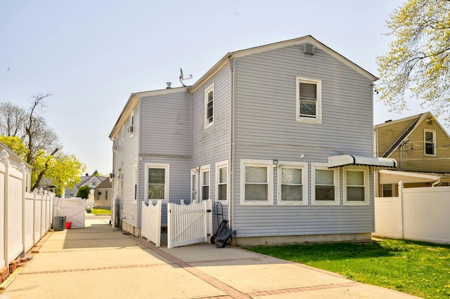 back of house with a gate and fence