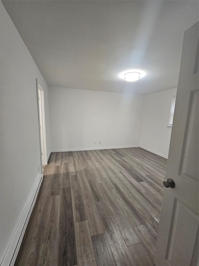 648 Lybolt Rd, Middletown, NY 10941 - unfurnished room with baseboards, a baseboard radiator, and dark wood finished floors