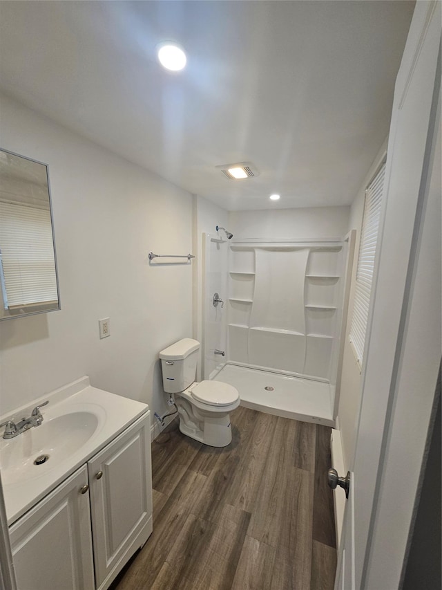 648 Lybolt Rd, Middletown, NY 10941 - full bathroom featuring wood finished floors, a stall shower, vanity, toilet, and recessed lighting