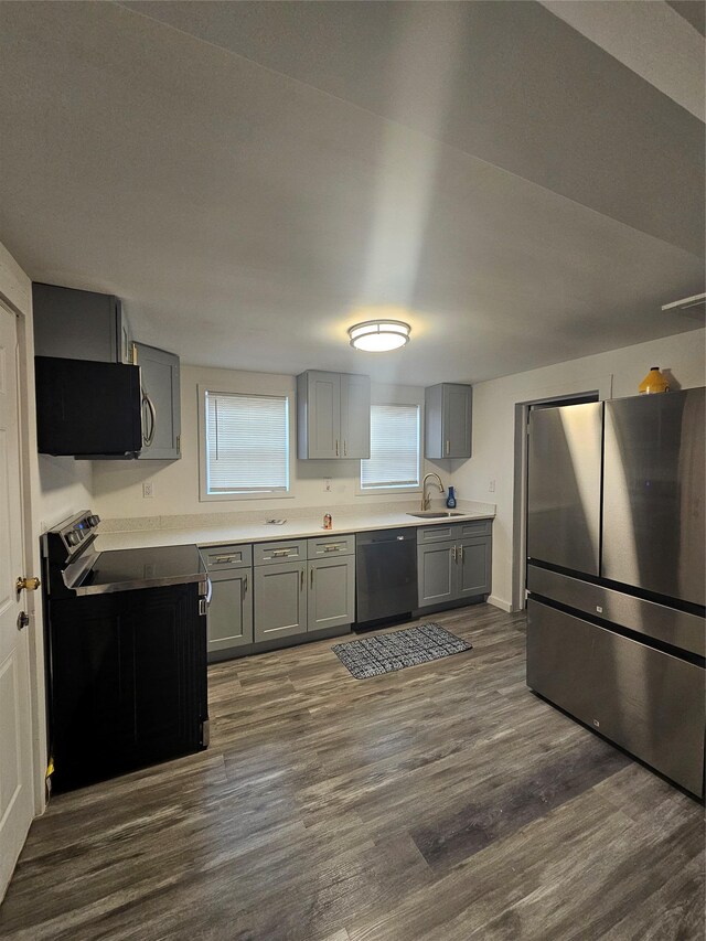 648 Lybolt Rd, Middletown, NY 10941 - kitchen with dark wood-style floors, light countertops, gray cabinets, a sink, and black appliances
