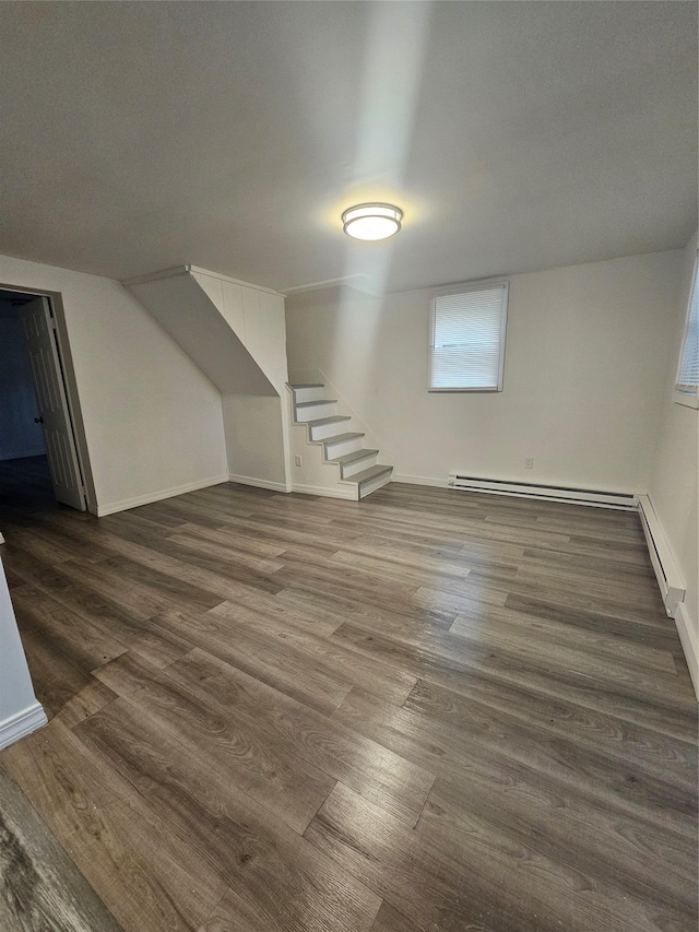 648 Lybolt Rd, Middletown, NY 10941 - additional living space featuring a baseboard radiator, baseboards, dark wood-style flooring, and stairs