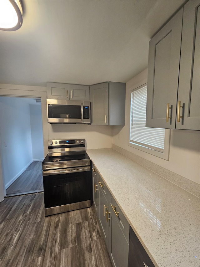 648 Lybolt Rd, Middletown, NY 10941 - kitchen featuring stainless steel appliances, dark wood-style floors, baseboards, gray cabinets, and light stone countertops