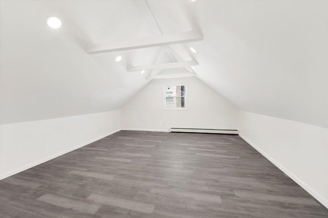 additional living space featuring a baseboard heating unit, lofted ceiling with beams, baseboards, and wood finished floors