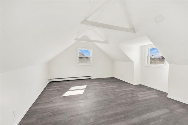 bonus room with a baseboard heating unit, baseboards, and wood finished floors