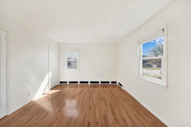 empty room with wood finished floors and baseboards