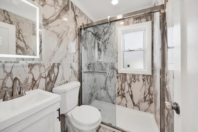 full bath featuring tile walls, a marble finish shower, vanity, and toilet