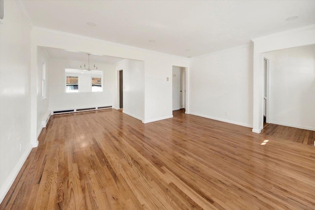 unfurnished living room featuring light wood finished floors, baseboards, a baseboard radiator, and ornamental molding