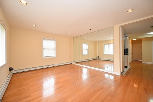 174-20 Jewel Ave, Fresh Meadows, NY 11365 - empty room featuring light wood-style floors, a baseboard radiator, a baseboard heating unit, and recessed lighting