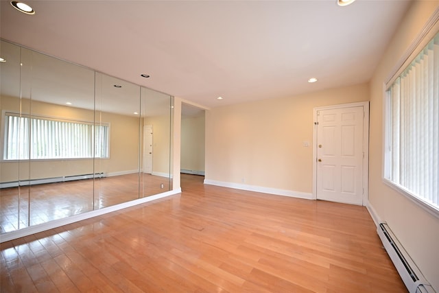 174-20 Jewel Ave, Fresh Meadows, NY 11365 - unfurnished room featuring a baseboard heating unit, light wood finished floors, and a baseboard radiator