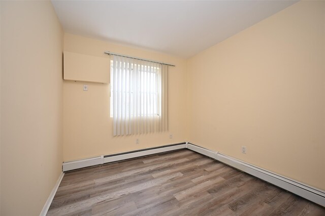 174-20 Jewel Ave, Fresh Meadows, NY 11365 - spare room featuring baseboards and wood finished floors