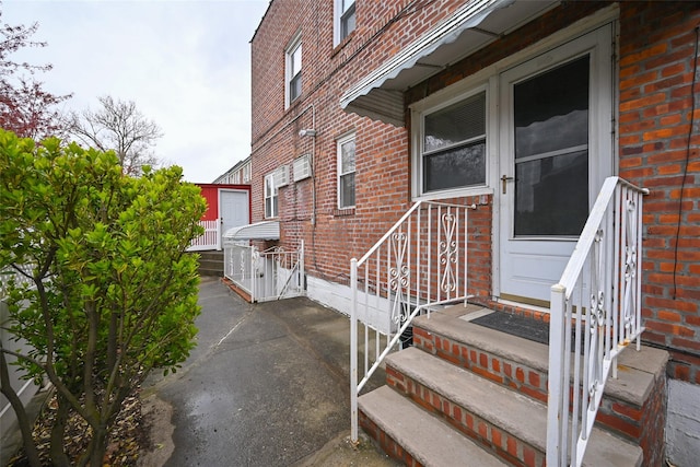 174-20 Jewel Ave, Fresh Meadows, NY 11365 - view of exterior entry with a patio area and brick siding