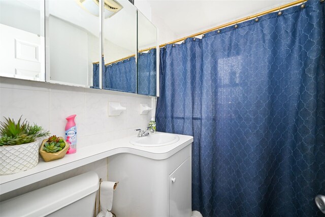 174-20 Jewel Ave, Fresh Meadows, NY 11365 - full bath with vanity, decorative backsplash, and toilet