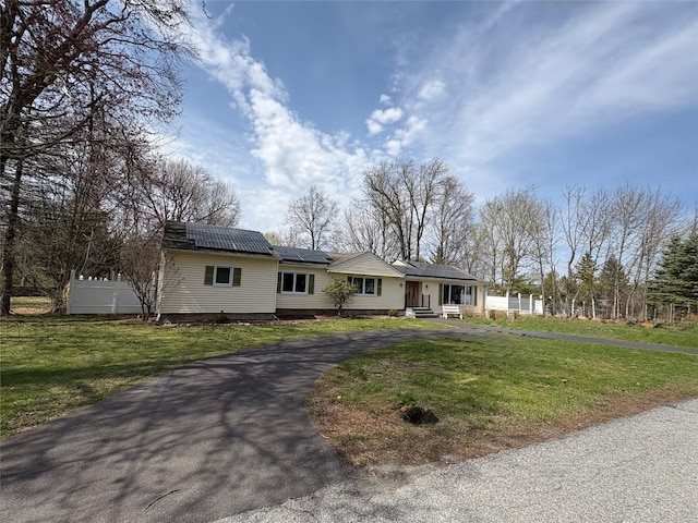 43 Overlook Rd, Monroe, NY 10950 - ranch-style home with roof mounted solar panels, driveway, fence, and a front yard