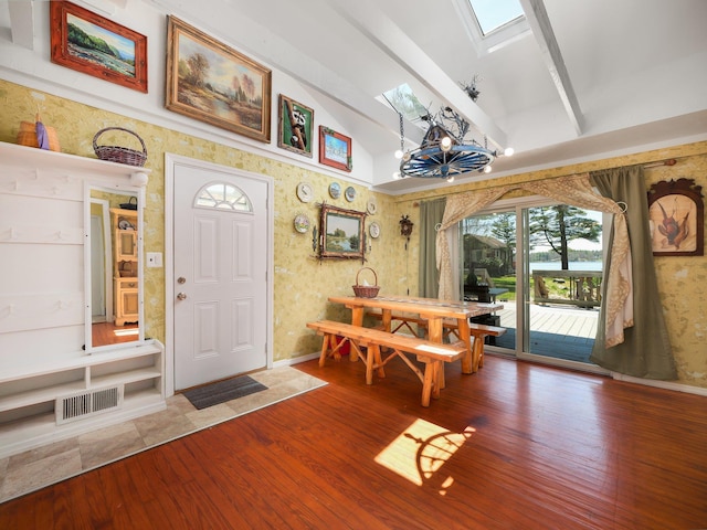 236 Lakeview Drive Rd, Eldred, NY 12743 - dining room featuring visible vents, a skylight, wood finished floors, high vaulted ceiling, and baseboards