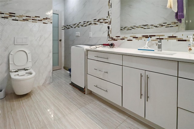 bathroom featuring vanity, tile walls, and toilet