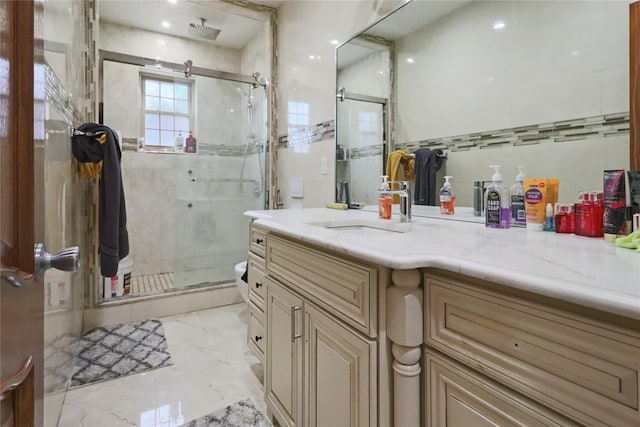 bathroom featuring vanity, marble finish floor, visible vents, and a stall shower