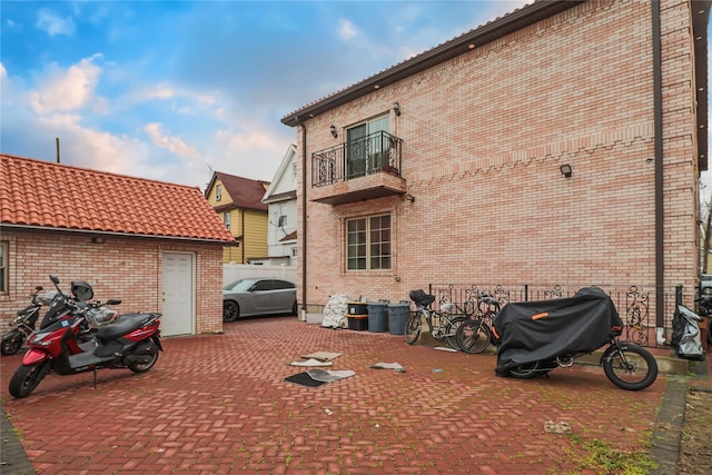 exterior space with grilling area and a balcony