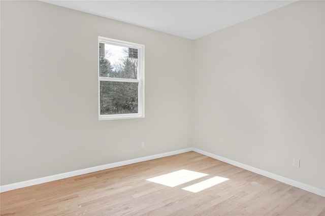 spare room with wood finished floors and baseboards