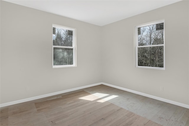 unfurnished room featuring wood finished floors and baseboards