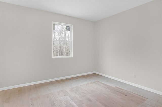 unfurnished room with wood finished floors and baseboards