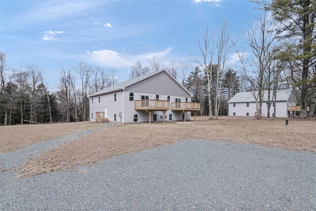 back of house with a wooden deck
