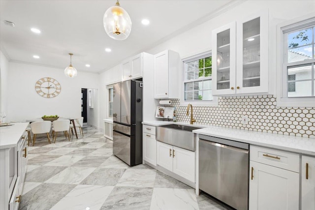 kitchen featuring stainless steel appliances, ornamental molding, a sink, backsplash, and glass insert cabinets