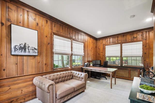 office space with ornamental molding, wooden walls, and carpet floors