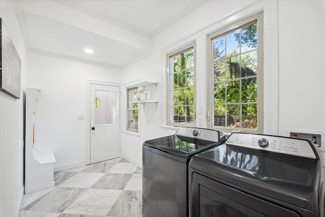 laundry area with crown molding, washing machine and clothes dryer, and baseboards