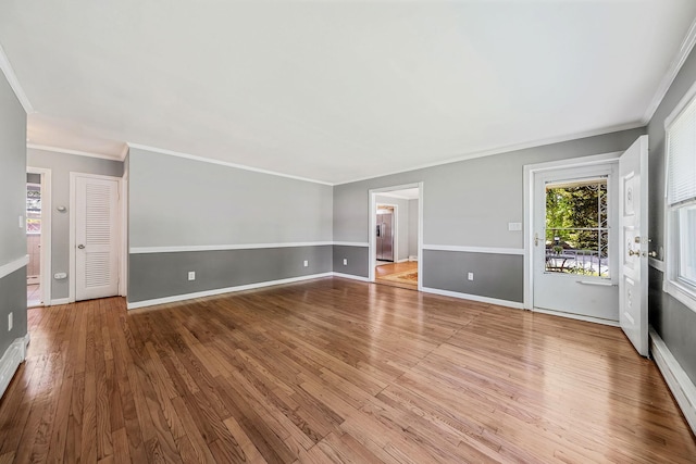 53 Abinet Ct, Selden, NY 11784 - unfurnished living room with ornamental molding, wood finished floors, and baseboards