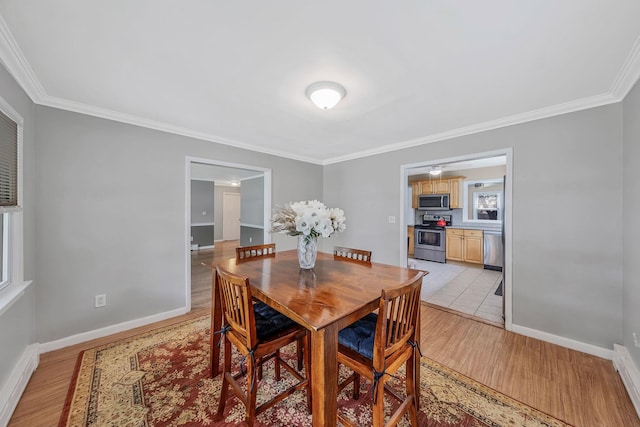 53 Abinet Ct, Selden, NY 11784 - dining room featuring ornamental molding, light wood-style floors, and baseboards