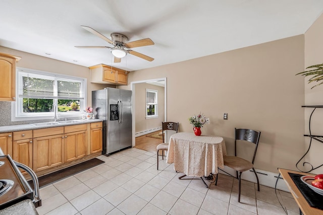 53 Abinet Ct, Selden, NY 11784 - kitchen with stainless steel fridge, a sink, baseboard heating, a ceiling fan, and plenty of natural light