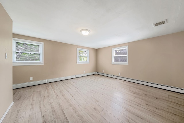 53 Abinet Ct, Selden, NY 11784 - empty room with wood finished floors, baseboards, and a baseboard heating unit