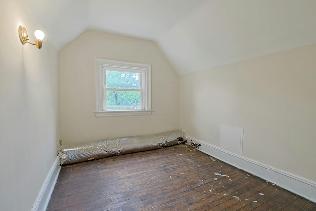 additional living space with wood-type flooring and vaulted ceiling