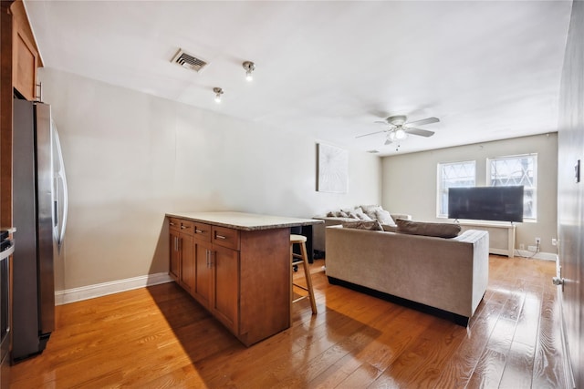 21-25 146th St, Whitestone, NY 11357 - living room with baseboards, a ceiling fan, wood finished floors, and visible vents
