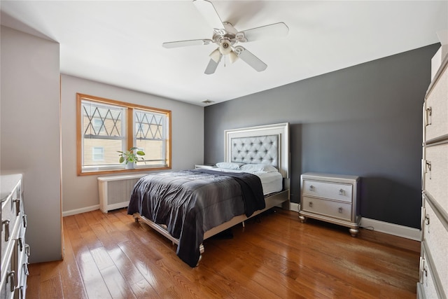 21-25 146th St, Whitestone, NY 11357 - bedroom with a ceiling fan, radiator heating unit, wood finished floors, baseboards, and visible vents