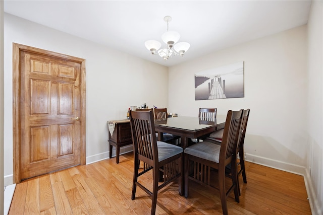 21-25 146th St, Whitestone, NY 11357 - dining space featuring light wood-style flooring, baseboards, and an inviting chandelier