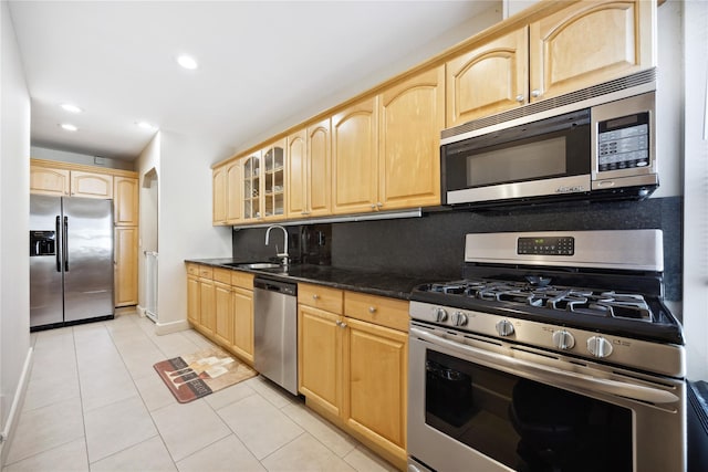 21-25 146th St, Whitestone, NY 11357 - kitchen with light brown cabinetry, light tile patterned floors, glass insert cabinets, stainless steel appliances, and recessed lighting