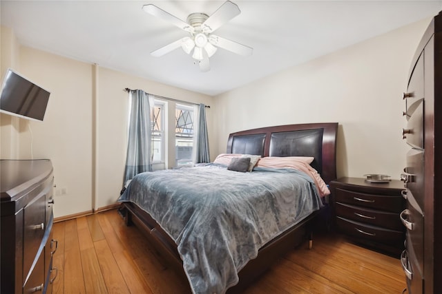 21-25 146th St, Whitestone, NY 11357 - bedroom featuring a ceiling fan, baseboards, and light wood-style floors