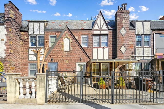 21-25 146th St, Whitestone, NY 11357 - view of front of home featuring brick siding, a gate, and a fenced front yard