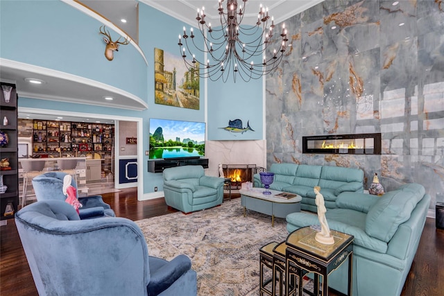 505 E Dr, Copiague, NY 11726 - living room with a premium fireplace, a towering ceiling, wood finished floors, crown molding, and a chandelier