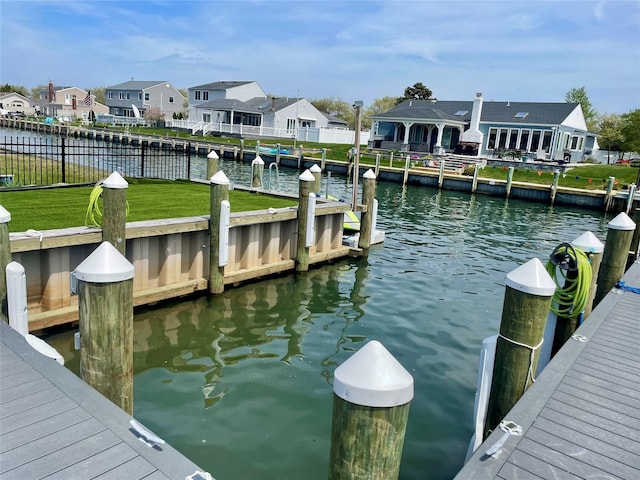 505 E Dr, Copiague, NY 11726 - dock featuring a residential view and a water view