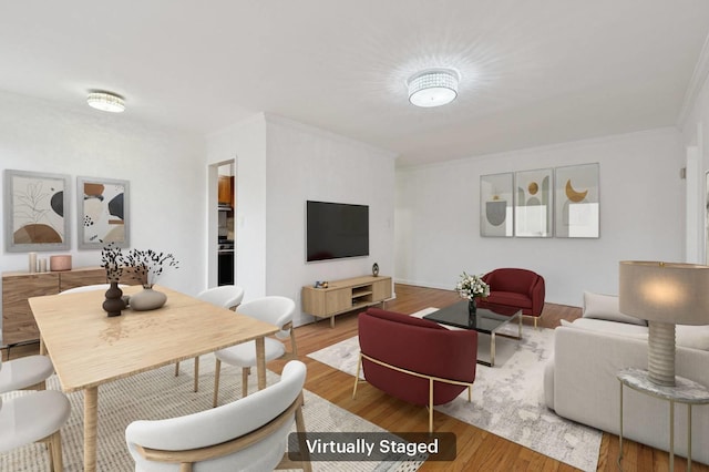 living room featuring crown molding and wood finished floors