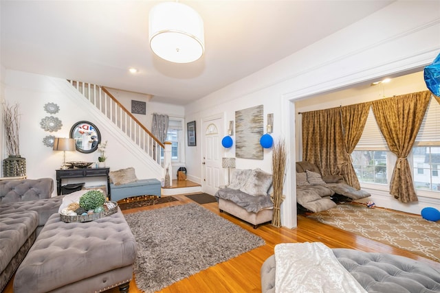 living room with wood finished floors and stairway